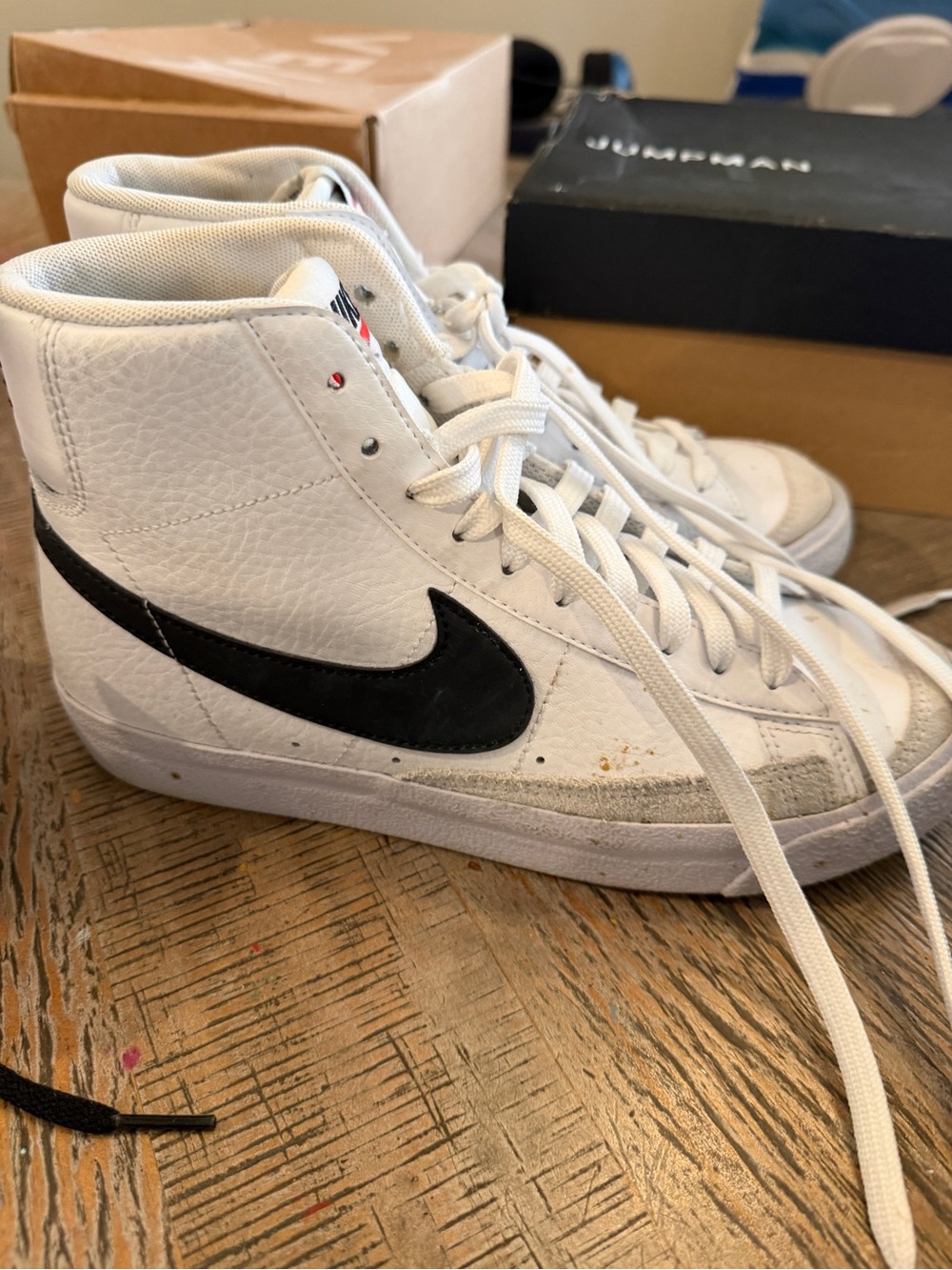 Nike White High-Top Sneakers with Black Swoosh